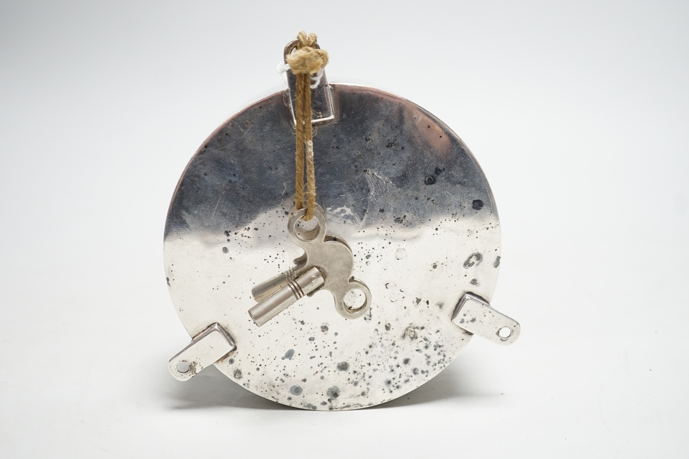 A small silver plated ship's clock, inscribed ‘Siren’ R.M.Y.C.